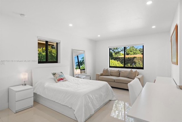 tiled bedroom featuring multiple windows