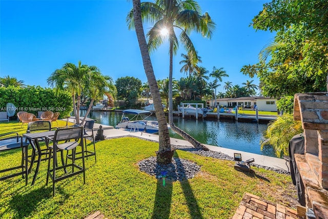 view of yard featuring a water view and a boat dock