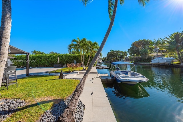 view of dock featuring a yard and a water view