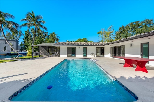 view of swimming pool with a lanai and a patio area