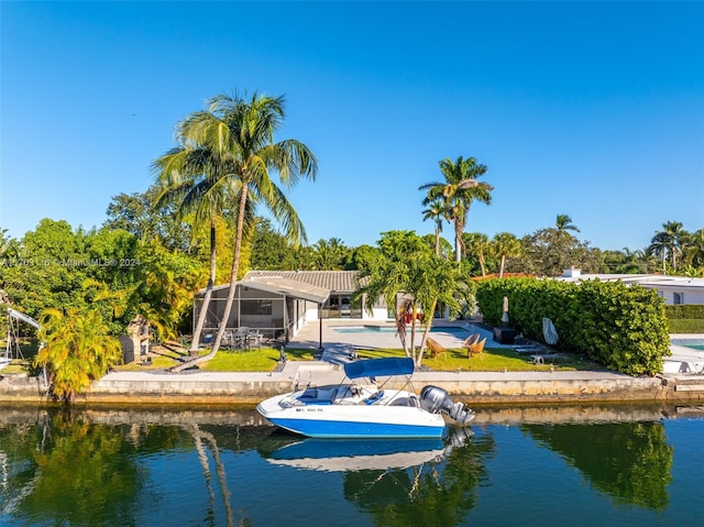 dock area with a water view, a patio area, and a lanai