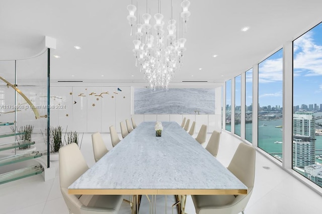 tiled dining area with a notable chandelier, expansive windows, and a water view