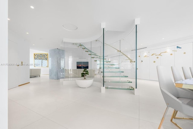 staircase featuring a fireplace and tile patterned floors