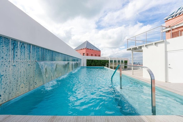 view of pool with pool water feature