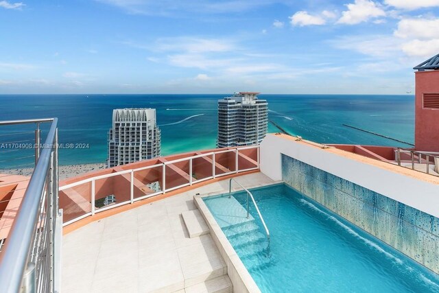 view of swimming pool featuring a water view