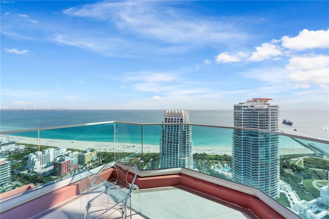 balcony featuring a water view and a view of the beach