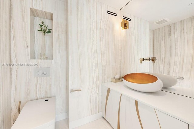 bathroom featuring tile patterned floors, vanity, and toilet