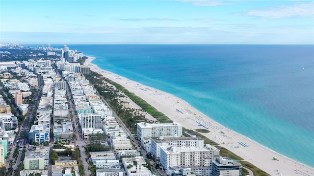 birds eye view of property with a view of the beach and a water view