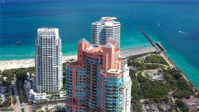 bird's eye view with a water view and a beach view