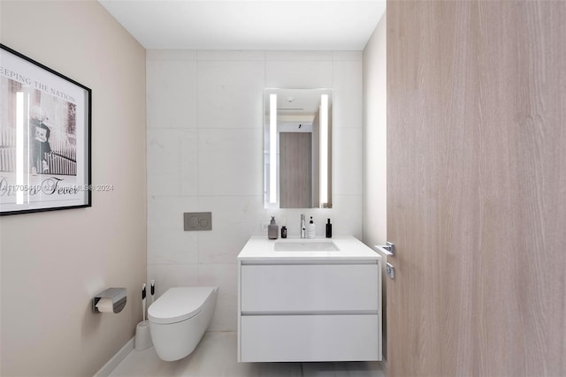 bathroom with vanity, toilet, and tile walls