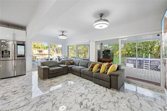 sunroom featuring ceiling fan