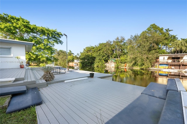 wooden terrace with a dock and a water view