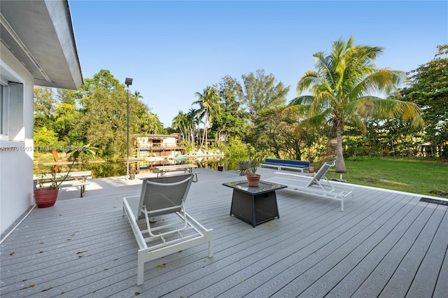 wooden deck featuring a yard