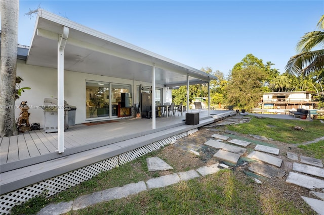 wooden terrace with a grill