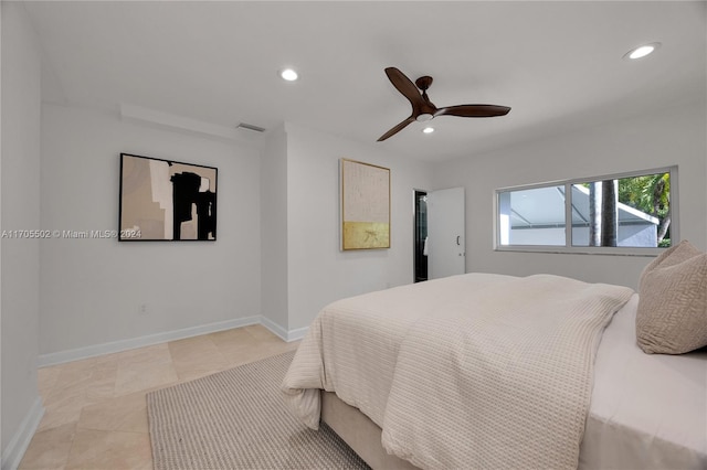 tiled bedroom featuring ceiling fan