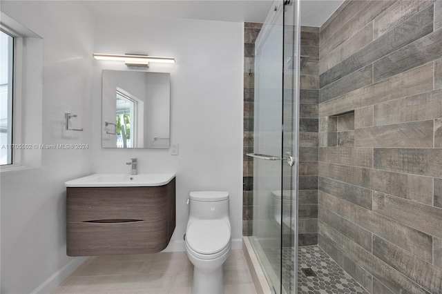 bathroom with tile patterned flooring, toilet, vanity, and walk in shower