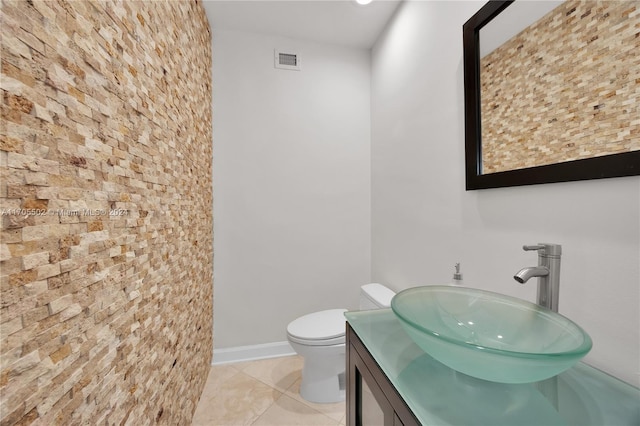 bathroom with tile patterned floors, vanity, and toilet