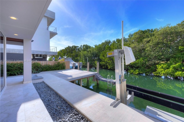 view of property's community with a boat dock and a water view