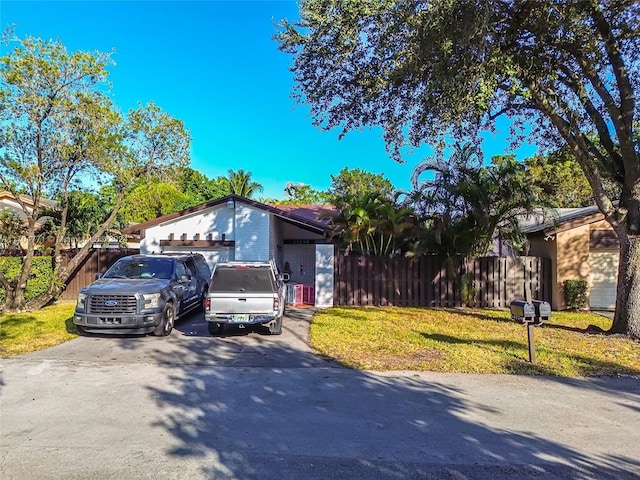 view of front facade with a garage and a front lawn