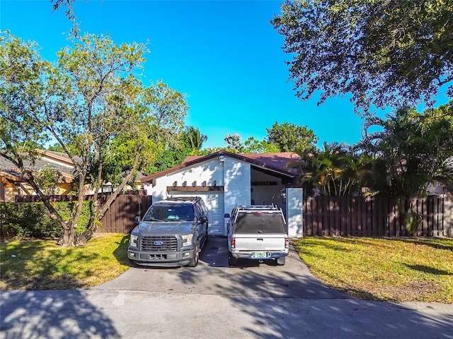 view of front of property featuring a garage and a front lawn