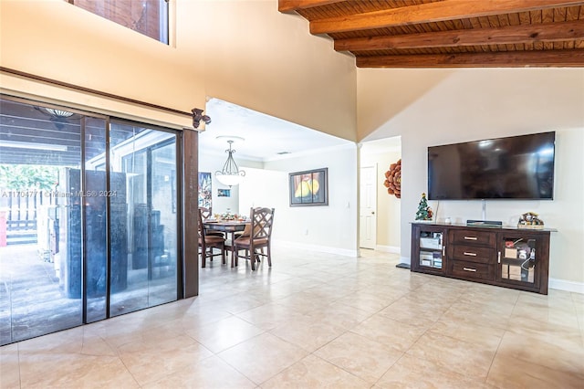 tiled living room with lofted ceiling with beams and wooden ceiling