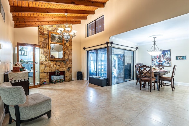 living room featuring beam ceiling, a notable chandelier, light tile patterned flooring, wood ceiling, and ornamental molding