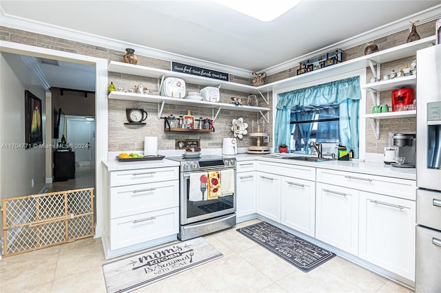 kitchen featuring sink, crown molding, electric range, light tile patterned flooring, and white cabinetry