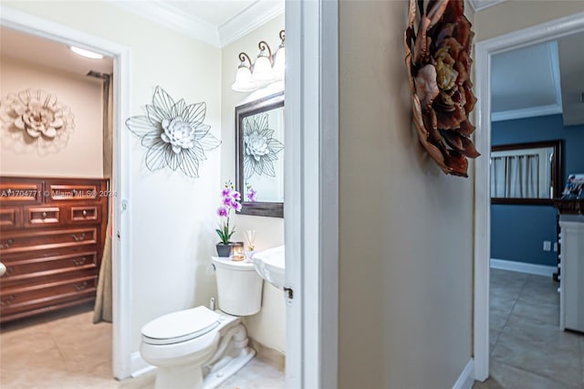 bathroom with tile patterned floors, toilet, and crown molding