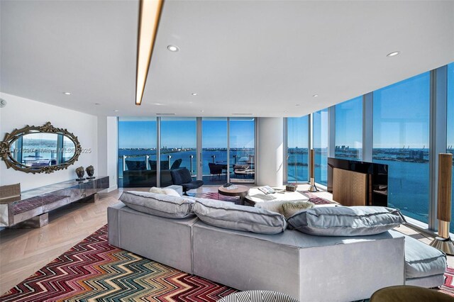 living room featuring a water view and expansive windows