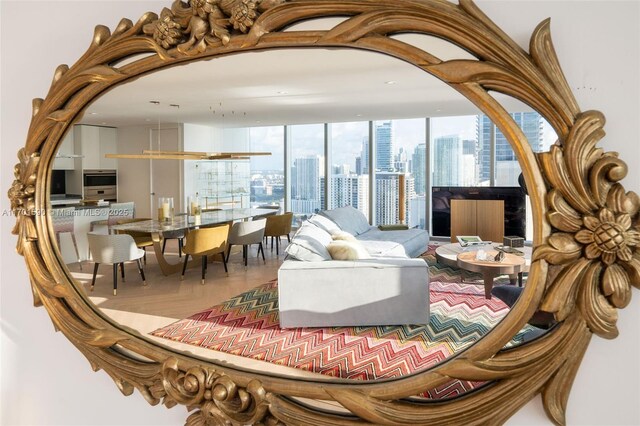 bedroom featuring access to outside, floor to ceiling windows, a water view, and parquet flooring