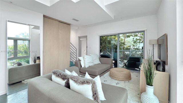 living room with a high ceiling and concrete floors