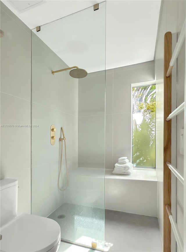 bathroom featuring toilet and walk in shower