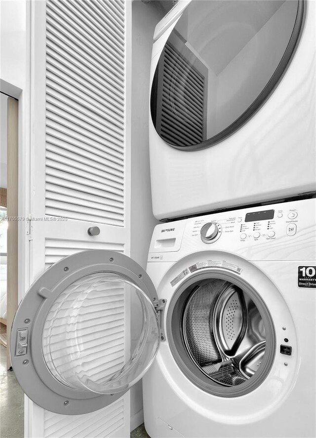 clothes washing area with stacked washer / drying machine