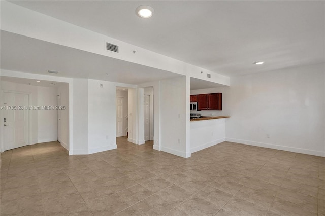 unfurnished living room with recessed lighting, visible vents, and baseboards