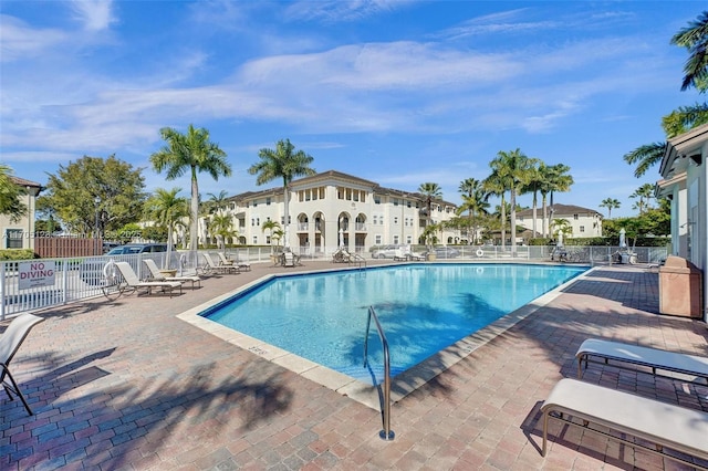 pool featuring a patio area and fence