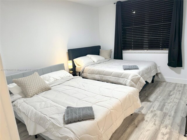 bedroom with light hardwood / wood-style flooring