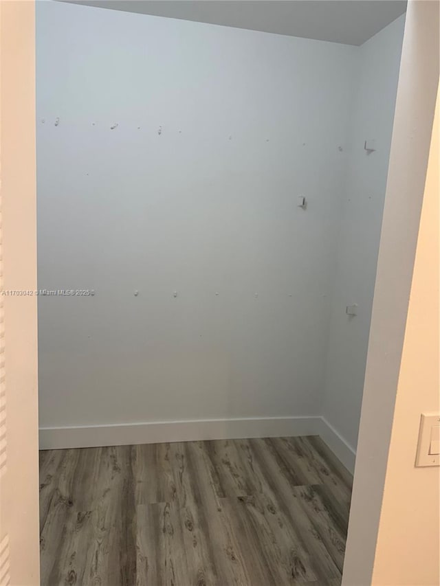 unfurnished room with hardwood / wood-style flooring