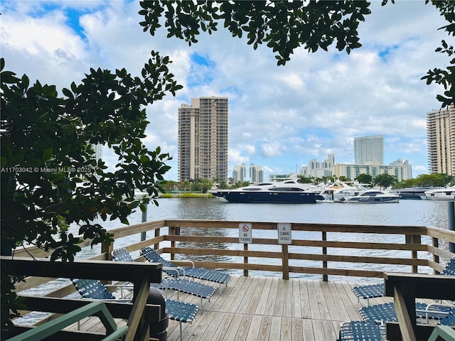 view of dock with a deck with water view