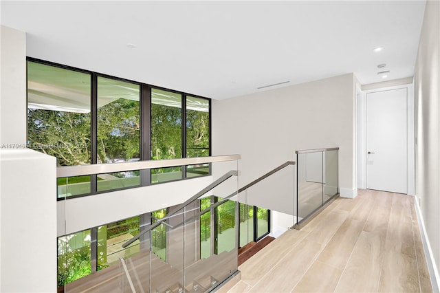 100 Hampton Ln, Key Biscayne, FL 33149 - hall with baseboards, an upstairs landing, recessed lighting, and wood finished floors