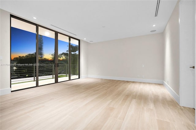 100 Hampton Ln, Key Biscayne, FL 33149 - spare room with a wall of windows, baseboards, and wood finished floors