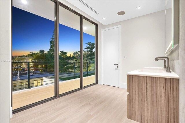 100 Hampton Ln, Key Biscayne, FL 33149 - entryway featuring light wood-style flooring and a sink