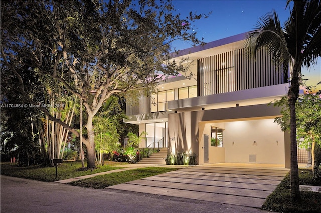 100 Hampton Ln, Key Biscayne, FL 33149 - modern home featuring stucco siding, a carport, and a balcony