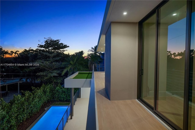 view of balcony at dusk