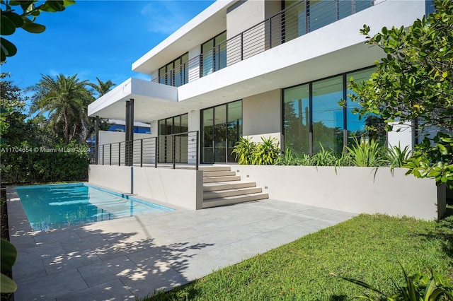 view of swimming pool featuring a patio area