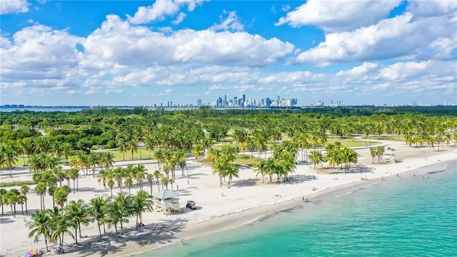 birds eye view of property with a view of the beach and a water view