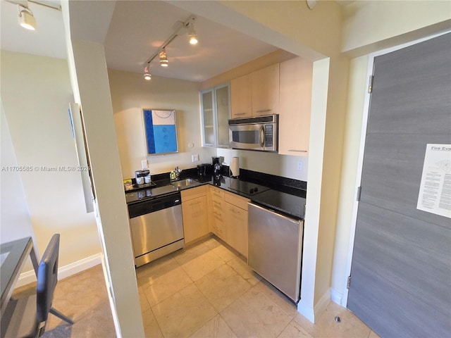 kitchen with appliances with stainless steel finishes, light brown cabinetry, and sink