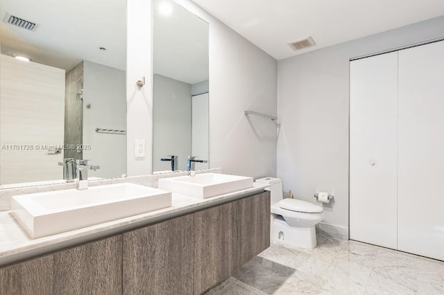 bathroom featuring walk in shower, vanity, and toilet