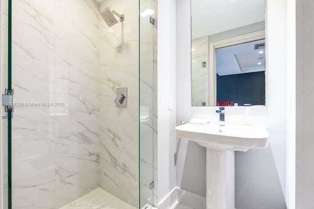 bathroom with an enclosed shower and sink