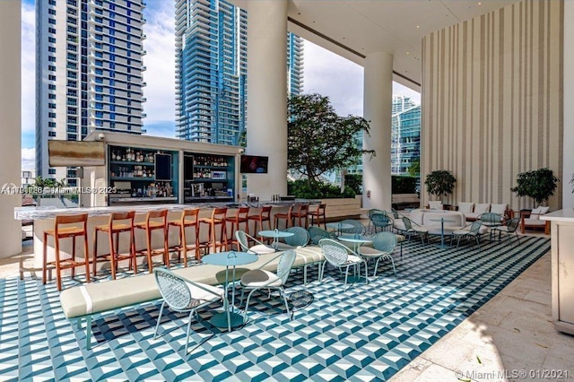 view of patio / terrace featuring a bar and an outdoor hangout area