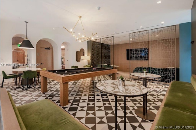 recreation room with a chandelier and billiards